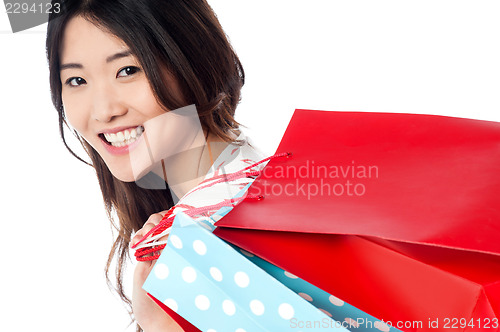 Image of Cheerful young shopaholic girl