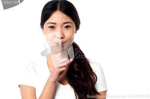 Image of Beautiful asian girl gesturing silence