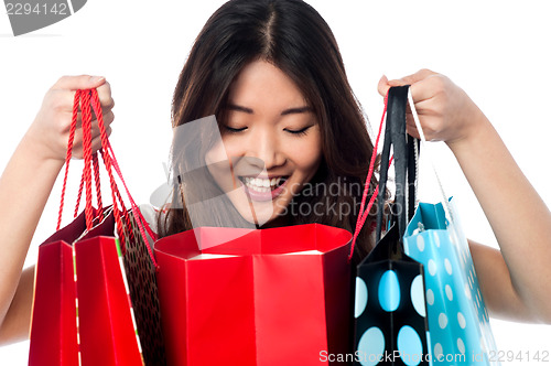 Image of Shopaholic girl holding shopping bags