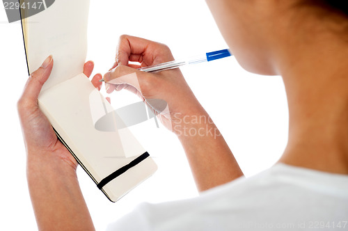Image of Waitress writing down customers order