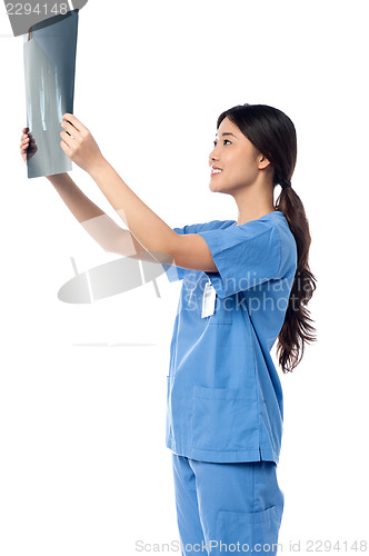 Image of Female doctor looking at scanned x-ray report