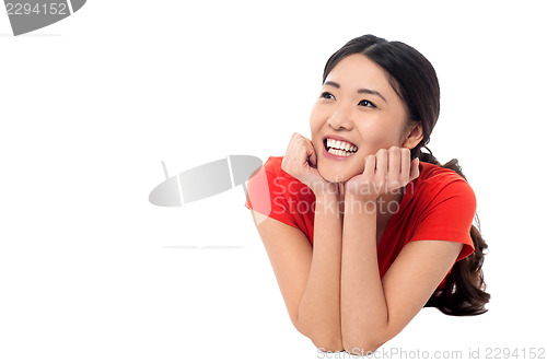 Image of Girl lying on studio floor and thinking something