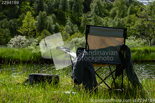 Image of Fisherman's chair by a river