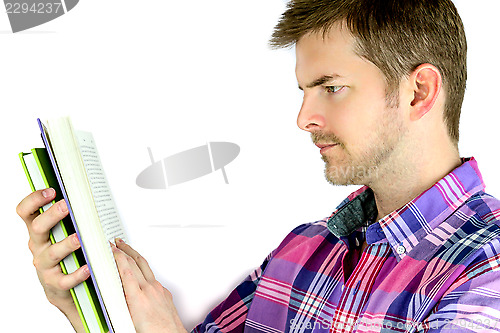 Image of Thoughtful young man reading a book