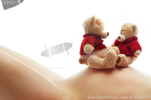 Image of Pregnant woman and teddy bears 