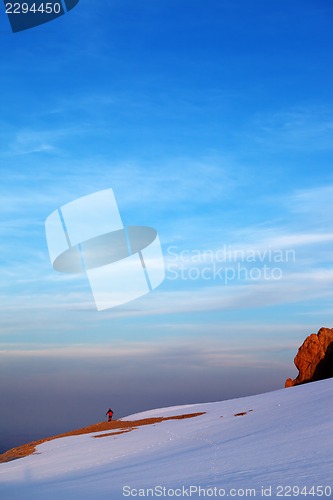 Image of Hiker in sunrise snow mountains