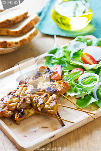 Image of Grilled chicken skewer with salad