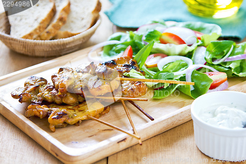 Image of Grilled chicken skewer with salad