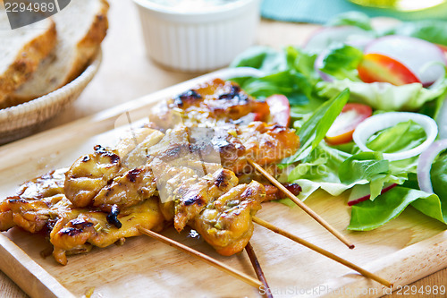 Image of Grilled chicken skewer with salad