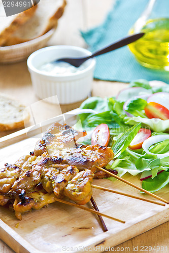 Image of Grilled chicken skewer with salad