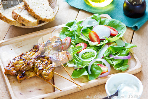 Image of Grilled chicken skewer with salad