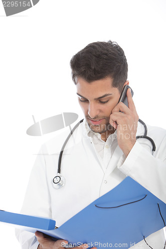 Image of Young male doctor talking on a mobile phone