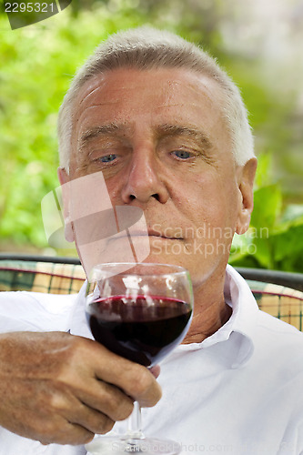 Image of Happy senior enjoying drink