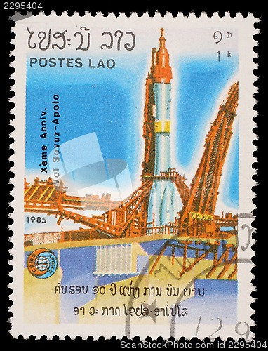 Image of Stamp printed in the Laos, is pictured launching the spacecraft Apollo Program Apollo-Soyuz