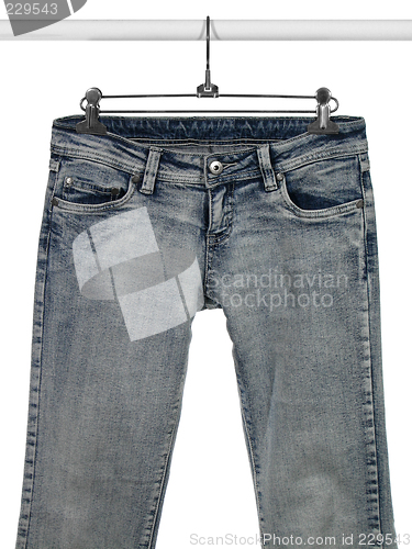 Image of Blue jeans on a closet rod