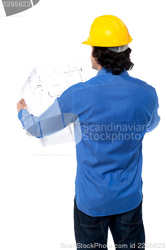 Image of Construction worker with blueprint plan