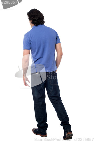 Image of Casual young guy walking in studio