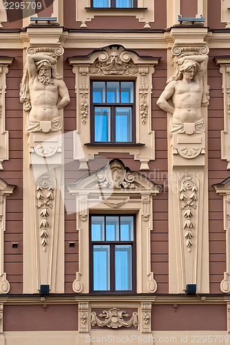 Image of The facade of the building with antique sculptures.