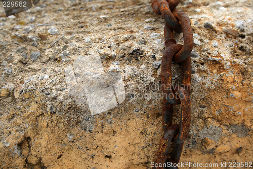 Image of Rusty chain on a stone