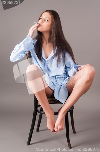 Image of beautiful young brunette woman with cigarette