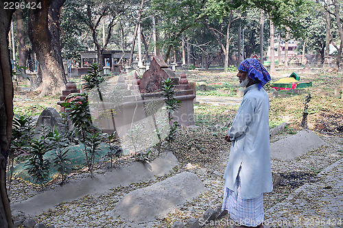 Image of Man prays in front of the grave on Muslim cemetery in Kolkata