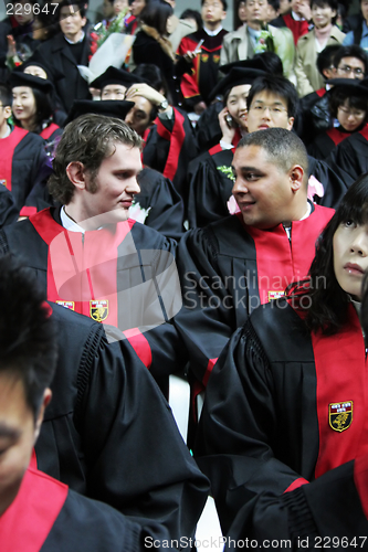 Image of International graduates at an Asian university chat during a gra