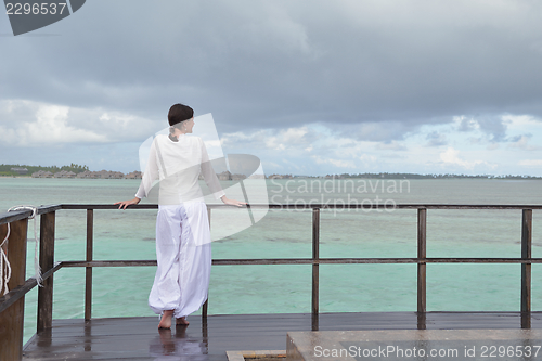 Image of young woman relax on cloudy summer day