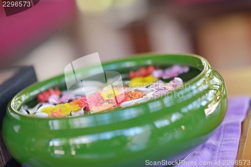 Image of water cup with beautiful flowers background