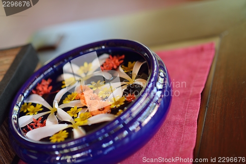 Image of water cup with beautiful flowers background