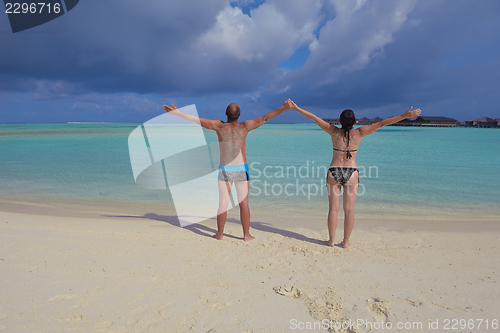 Image of happy young  couple at summer vacation have fun and relax at bea