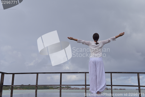 Image of young woman relax on cloudy summer day