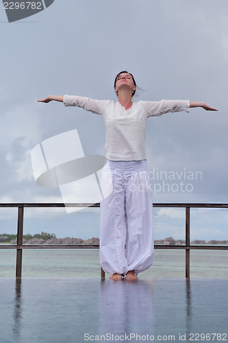 Image of young woman relax on cloudy summer day