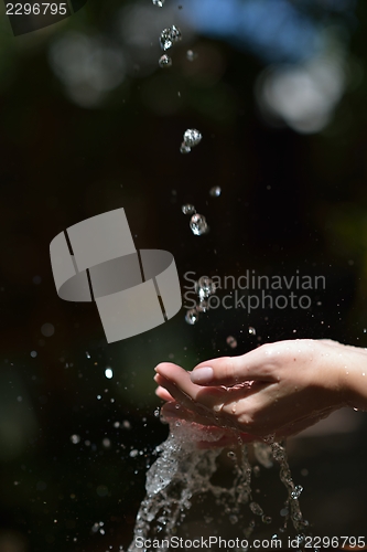 Image of water stream on woman hand