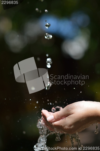 Image of water stream on woman hand