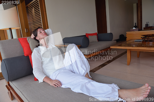 Image of happy young woman relax at home on sofa