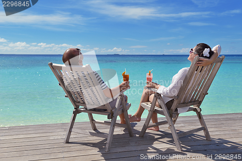 Image of happy young couple relax and take fresh drink