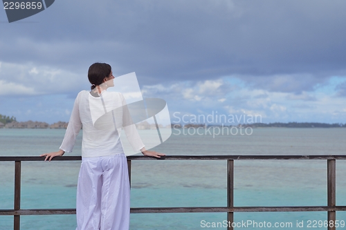 Image of young woman relax on cloudy summer day