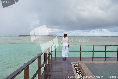Image of young woman relax on cloudy summer day