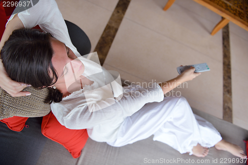 Image of happy young woman relax at home on sofa