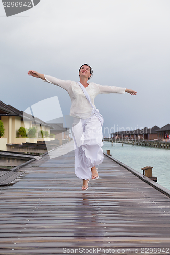 Image of young woman relax on cloudy summer day