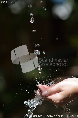 Image of water stream on woman hand