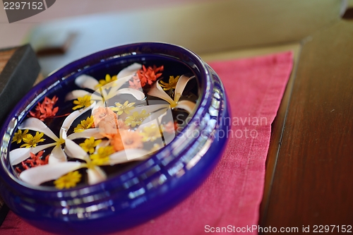 Image of water cup with beautiful flowers background