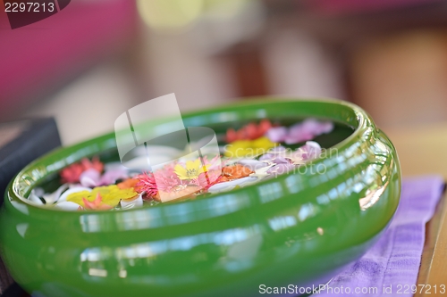 Image of water cup with beautiful flowers background
