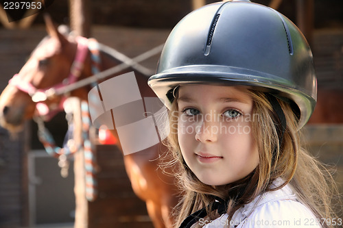 Image of Little girl and brown Horse