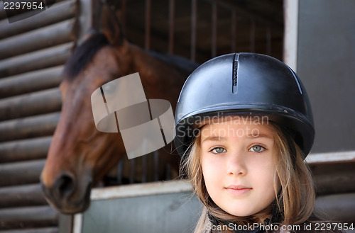Image of Little girl and brown Horse
