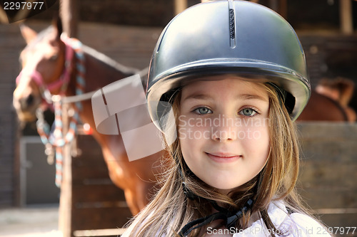 Image of Little girl and brown Horse