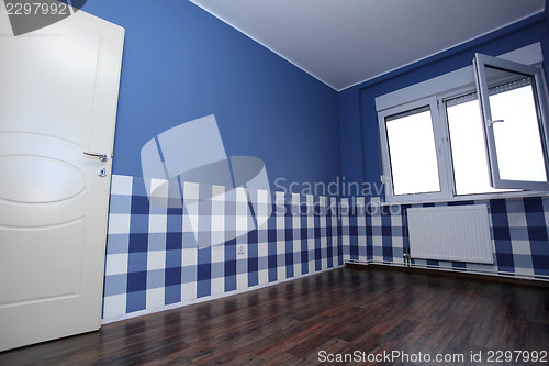 Image of empty room with a blue wall and blue-white wallpaper 