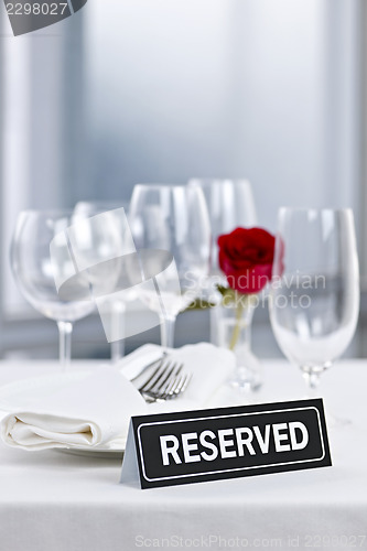 Image of Romantic dinner setting with reserved sign