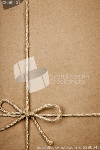 Image of Package in brown paper tied with string