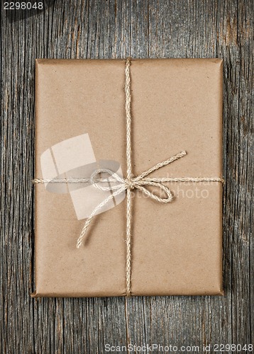 Image of Gift in brown paper tied with string